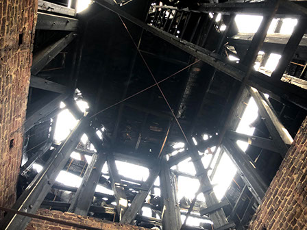 View looking up inside steeple, showing extent of damage by fire.