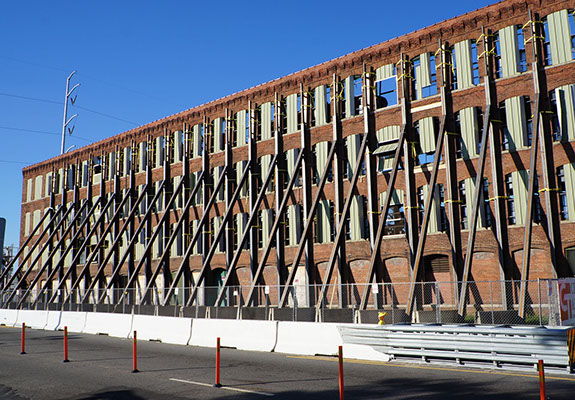 Select demolition of old Cigar Factory in Norfolk, where entire building was deconstructed leaving only the brick facade.
