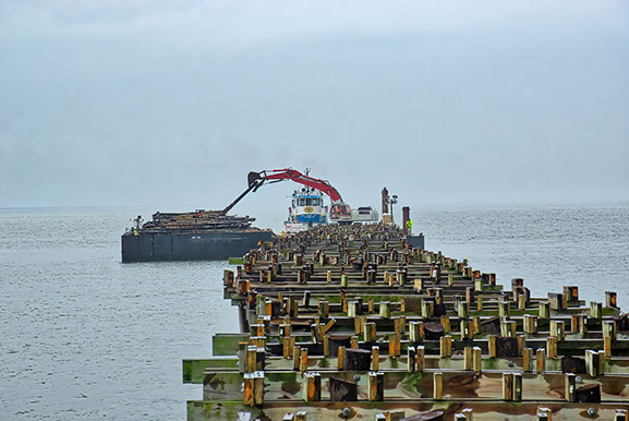 Lynnhaven Fishing Pier-view of pier during piling removal by barge.