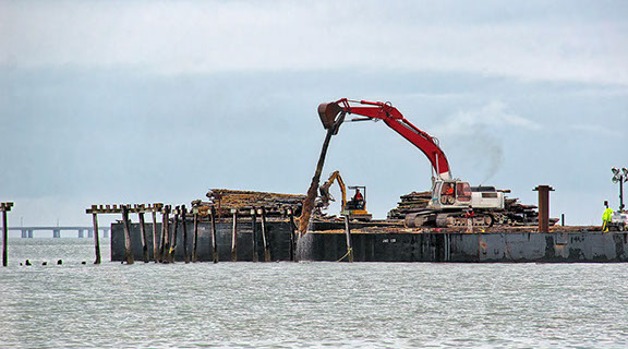 Lynnhaven Fishing Pier-view showing excavator removing pilings from barge.