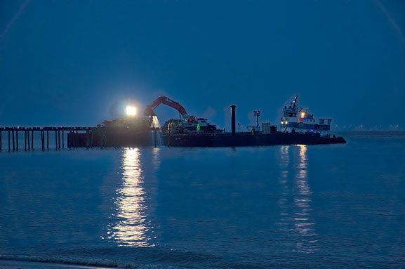 Lynnhaven Fishing Pier-view showing barge lights and piling removal at night