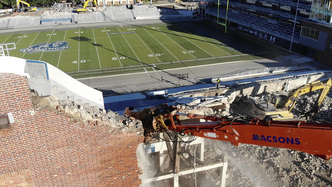 View taken by a drone, showing an excavator chewing away at the stadium.