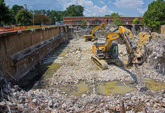 Excavators clearing out rubble to be reused in lanscaping of Water Treatment Plant, after heavy demolition.